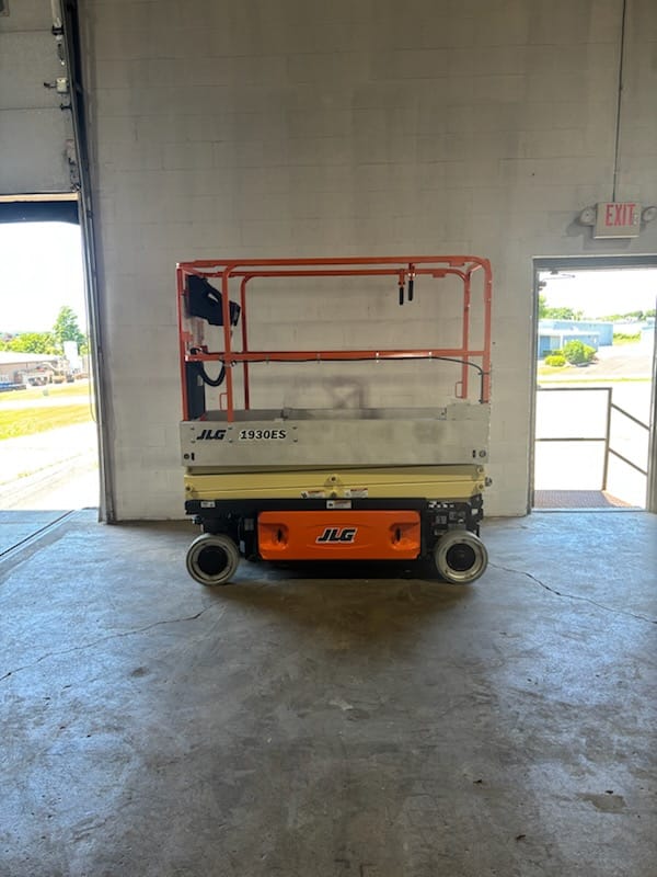JLG 1930ES scissor lift in the shop doorway at AWPS in Germantown, Wisconsin