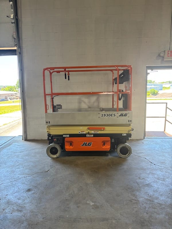 JLG 1930ES scissor lift in the shop bay for inspection