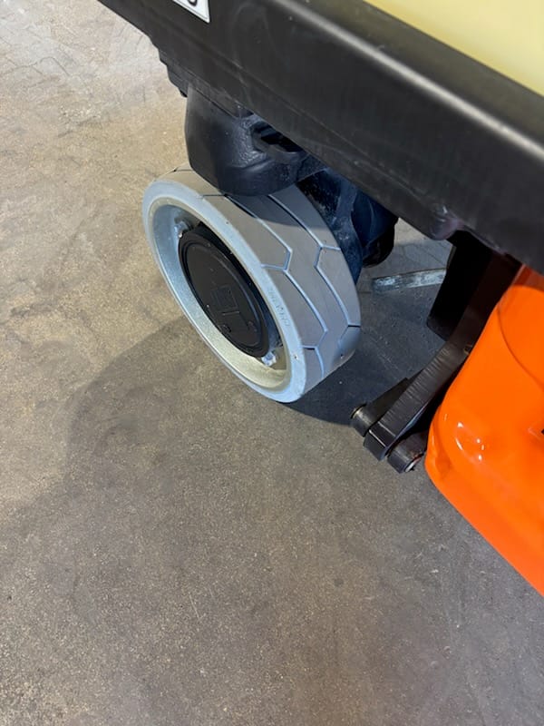 Solid non-marking tire on a JLG 1930ES drive wheel